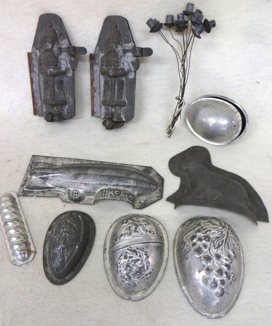 Collection of old tin chocolate molds including two: Collection of old tin chocolate molds including two 6.5" Santa Claus molds, egg shaped mold - grouping 1/2 tin molds including submarine, rabbit and 3 egg shaped molds - also a grouping of 10 tin Chri