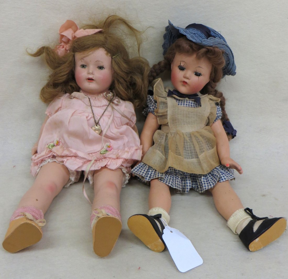 Pair of vintage effanbee dolls including an 18": Pair of vintage effanbee dolls including an 18" composition doll signed on neck and head with crackling at eyes, legs and thighs and crazing throughout, in her original gingham outfit slightly soiled,