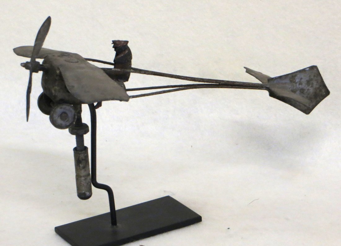 Unusual small folkart tin airplane whirligig with: Unusual small folkart tin airplane whirligig with propeller & pilot - original silver/gray paint - early 20th century - 10.5"L x 7" wingspan.