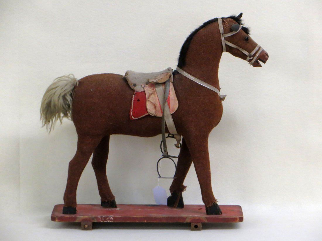Wooden horse pull toy19th century mohair over burlap,: Wooden horse pull toy19th century mohair over burlap, base has original red paint, missing wheels, has a repair to one hoof and loss at mane and mohair body otherwise in good condition. Measures 24" L