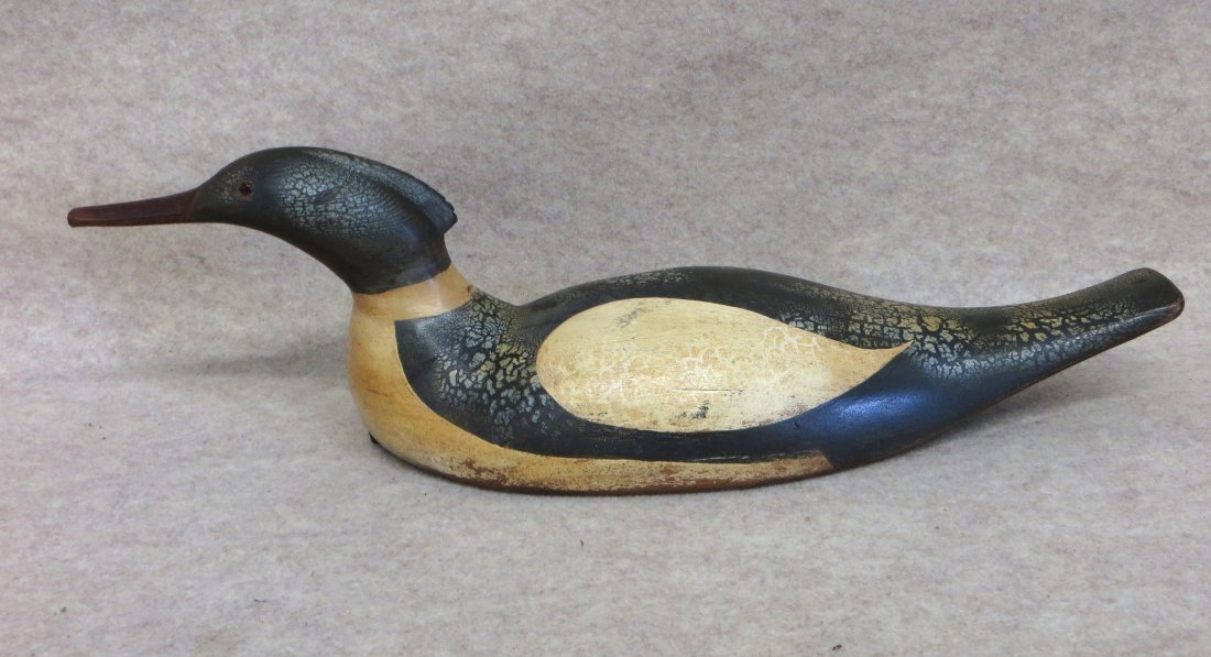 Swimming Merganser decoy in original paint with glass: Swimming Merganser decoy in original paint with glass eyes - some crazing to paint - some white splotches - missing weight - minor wear around base - overall good structural condition - 18.5"L.