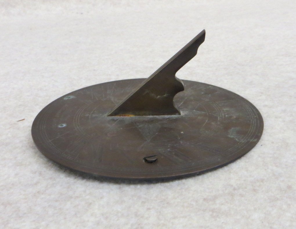 Small brass sundial with incised Roman numerals around: Small brass sundial with incised Roman numerals around perimeter surrounding central star - signed Van Cort Instrument Makers - 5.5"D. 19th century. From the estate of Elliott Steckel, Sharon Connecti