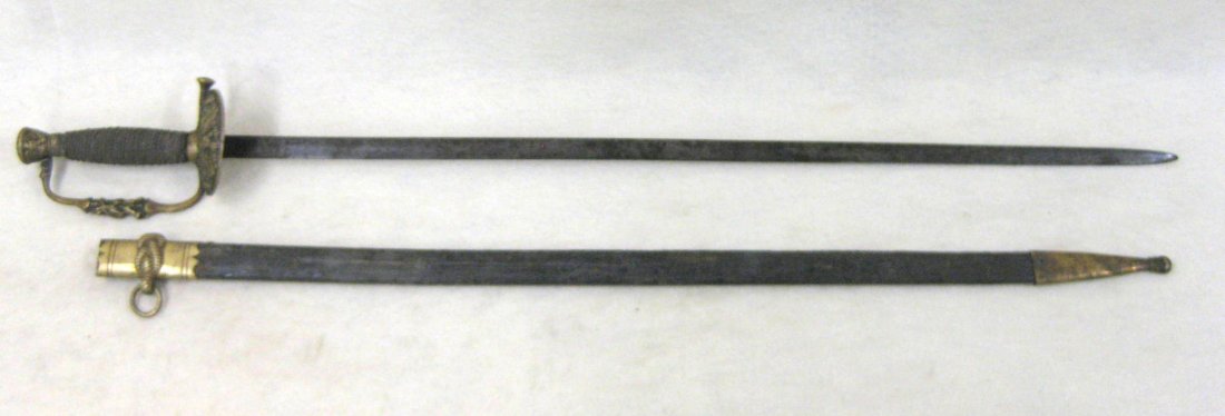 US Model 1860 Field Officer's sword with leather: US Model 1860 Field Officer's sword with leather scabbard. Brass pommel with floral top and embossed American eagle on side. Handle decorated with rifles on one side and arrows & shield on the other s
