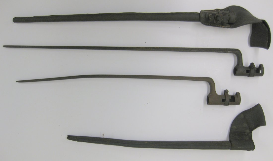 Two 19th century bayonets with leather scabbards with: Two 19th century bayonets with leather scabbards with belt loop ,double fluted sides and 1 flat surface with slight fluting. One with no markings - Overall 20.75"L - socket 3"L - slight bend to blade,