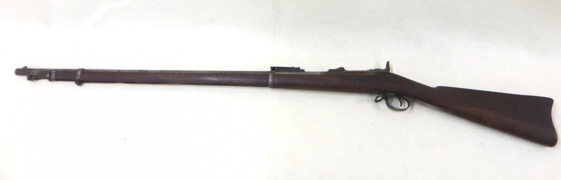 US Springfield Model 1884 Trapdoor Percussion Rifle: US Springfield Model 1884 Trapdoor Percussion Rifle Serial number 58765, the lock plate engraved with an eagle with shield to its breast and stamped US SPRINGFIELD; 36” long round barrel with front 