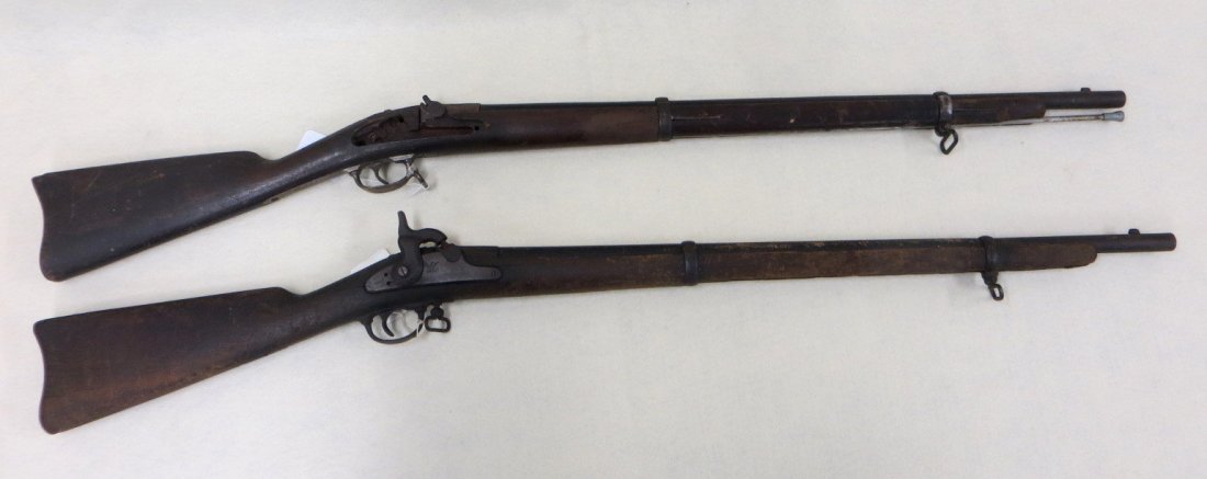 Two Springfield model 1863 training rifles. The first: Two Springfield model 1863 training rifles. The first training rifle utilizes a Springfield Model 1863 lock plate, trigger guard and swivel, the barrel is 19"L in wood and roughly 8" in steel with a f