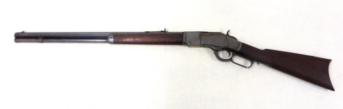 Winchester model 1873 lever action 44-40 rifle,: Winchester model 1873 lever action 44-40 rifle, manufactured in 1884. Blade front and adjustable rear sights. Signed "Winchester's-Repeating-Arms New Haven,CT / King's - Improvement - Patented - March