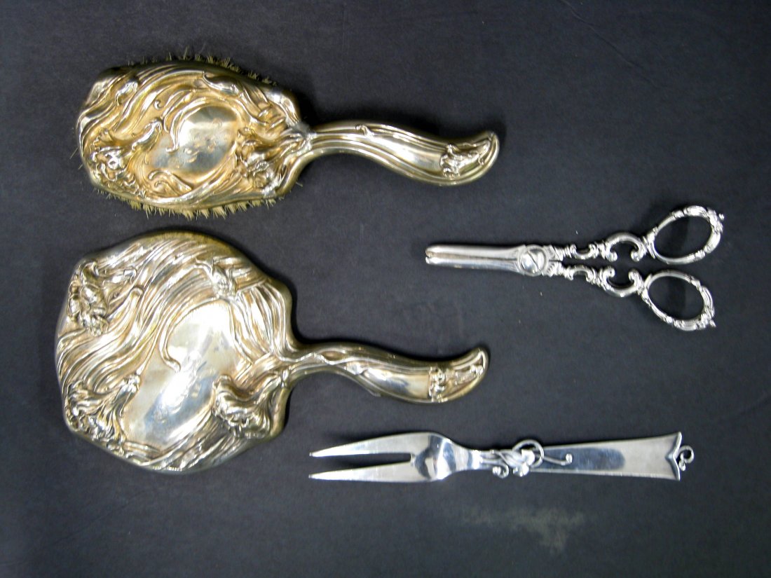 Four silver table/vanity articles including Frank: Four silver table/vanity articles including Frank Whiting Sterling Art Nouveau lady's hair brush and matching hand mirror; signed Cohr Sterling Denmark serving fork, and a signed Tiffany electro-plate