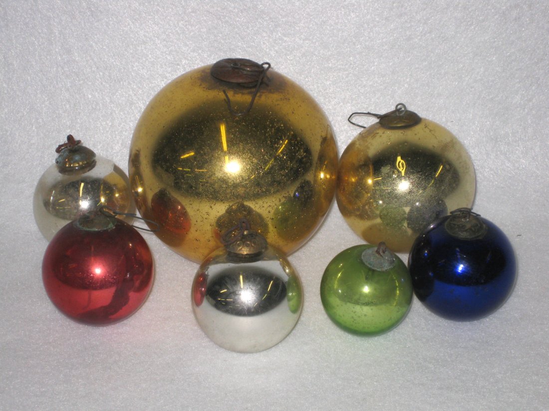 Collection of 7 Victorian German kugels in the form of: Collection of 7 Victorian German kugels in the form of glass balls with original ornamental hangers. Colors include silver, gold, blue, green and red - all in good condition. Size range 1.75"D to 4"D.