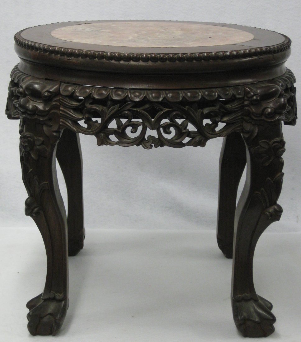 Fancy Oriental walnut plant stand with rose colored: Fancy Oriental walnut plant stand with rose colored marble insert, having heavily carved open work apron, and heavily carved legs terminating in ball and claw feet - beadwork around perimeter of top..