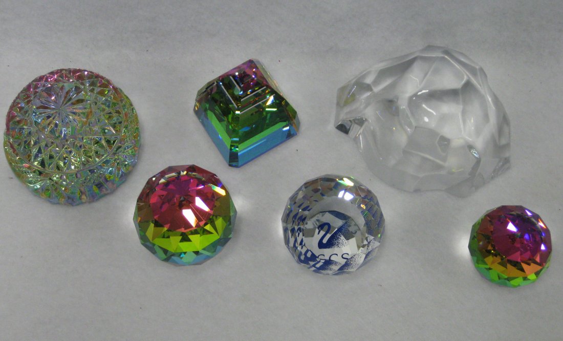 Six glass paperweights: 2 Swarovski faceted crystals: Six glass paperweights: 2 Swarovski faceted crystals including multi-colored pyramid shape - 2.25"H & ball shape - 1.75"H, 2 other unsigned multi-colored crystal faceted balls probably Swarovski - 1,5