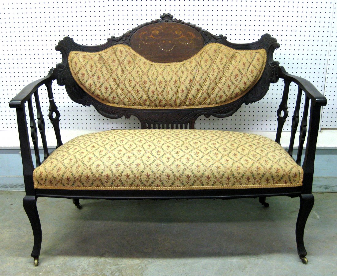 Edwardian upholstered settee with shaped wooden frame: Edwardian upholstered settee with shaped wooden frame and back crest decorated with floral inlay and mother-of-pearl. Very good condition. 49"L.