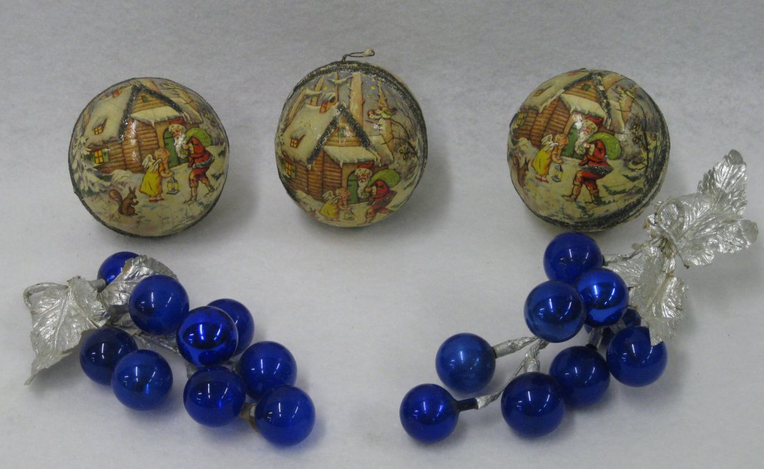 Three German lithographed paper mache Christmas: Three German lithographed paper mache Christmas ornament, candy container balls together with a pair of grape from blue glass Christmas ornaments with silver leaves. Circa 1940. All in good condition.