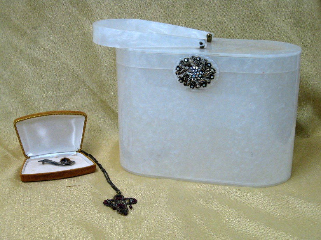 Marbleized white pearl Lucite lady's hand bag signed: Marbleized white pearl Lucite lady's hand bag signed Wilardy - Rhinestone jeweled clasp and interior mirror on lid - 10"L x 5"W x 7"H. Excellent condition. Circa 1950; together with 2 pieces of costum