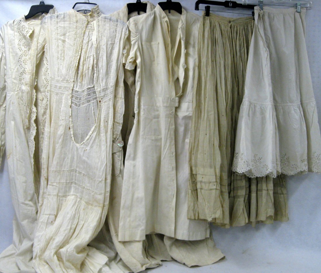 Six Victorian era women's white garments: Six Victorian era women's white garments including 2 skirts, 2 car coats, and 2 night gowns with embroidery work. Most with some staining and minor losses.
