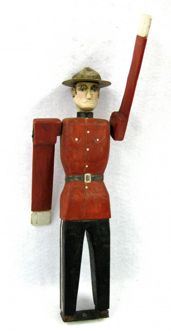 Hand made polychrome wooden folk art whirligig of: Hand made polychrome wooden folk art whirligig of Canadian Mounted Policeman - hat with metal rim - signed on base "M & J.C.B. / Vancouver B.C.". Very good condition in original paint. Circa 1940-50.