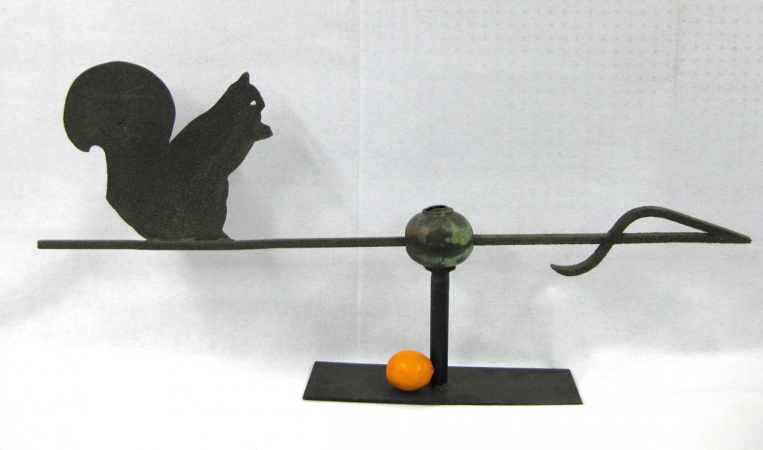 Silhouette sheet metal squirrel weathervane with cast: Silhouette sheet metal squirrel weathervane with cast iron arrow directional - central ball but missing finial. Probably mid 19th century. Overall length of arrow 52". Squirrel 13"H x 15.5"L. The meta