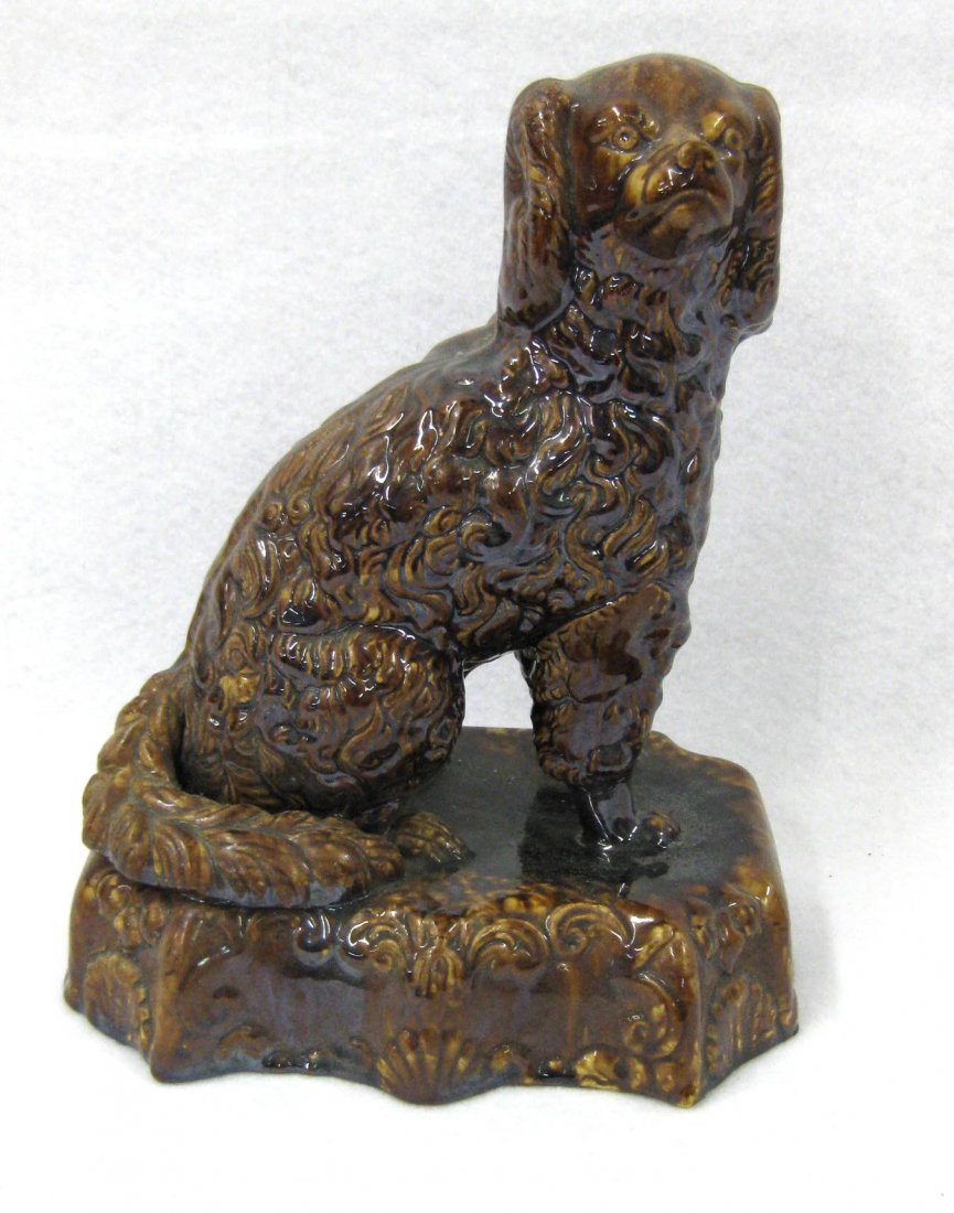 Yellowware seated spaniel with Rockingham style glaze,: Yellowware seated spaniel with Rockingham style glaze, probably mid 19th century. 10.75"H x 8.5"L. One tiny surface chip on base, otherwise excellent condition. Provenance: The Van Benscotten homestea