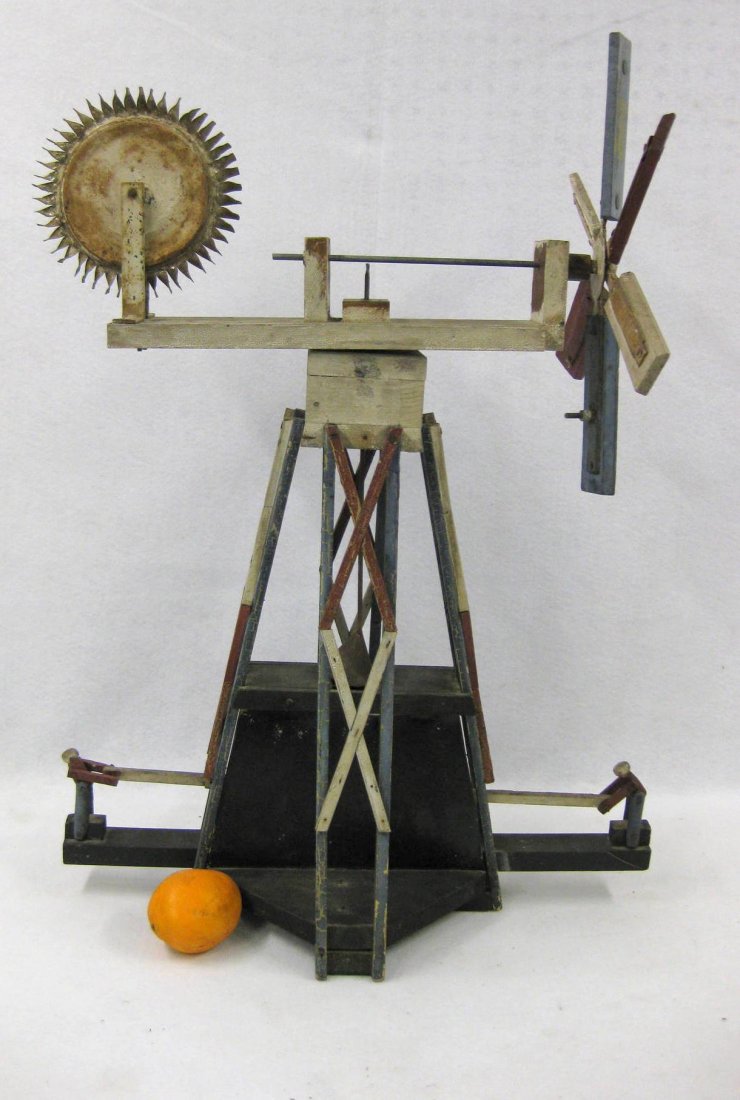 Folk art whirligig of 2 men pumping well in original: Folk art whirligig of 2 men pumping well in original red, white and blue paint - late 19th century - tin and wood construction. 31"H x 21.5"L. Missing one of the two turning wheel mechanisms otherwise