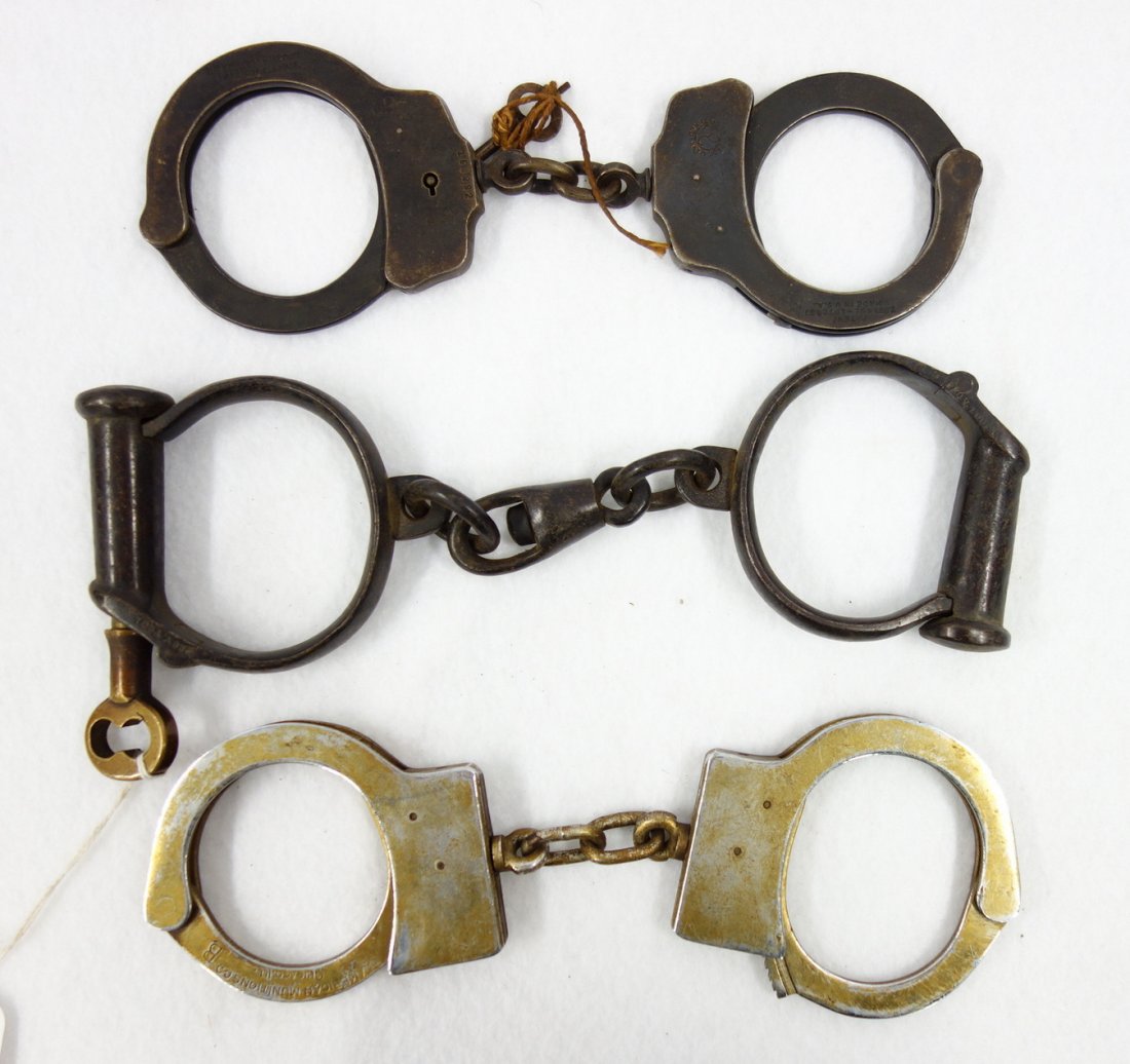 Three pairs of old handcuffs including "American (1 of 4)