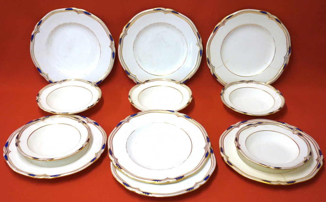 Twelve pieces of signed Mintons china with blue and: Twelve pieces of signed Mintons china with blue and gold decoration including five bowls 8" in diameter and seven dinner plates 11" in diameter. Two plates and one bowl have cracks, otherwise good con