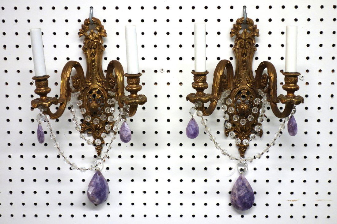 Pair of brass wall sconces with glass prisms and purple: Pair of brass wall sconces with glass prisms and purple quartz drops. 15" H. Very good condition. Early 20th century.