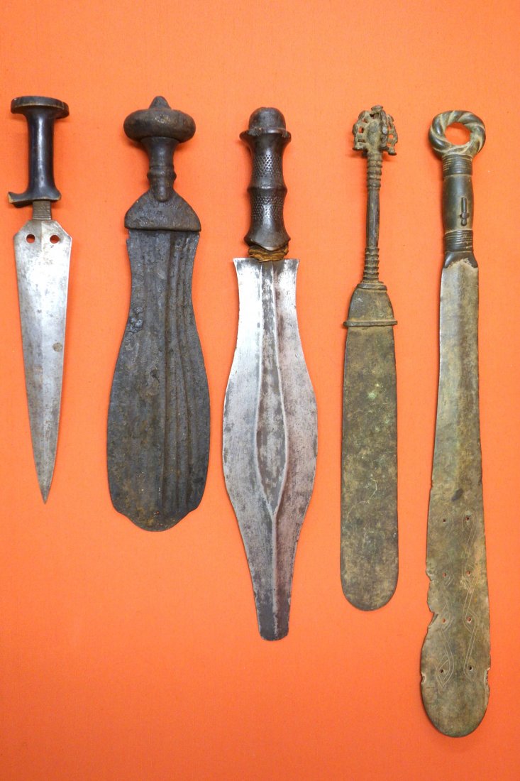 Five middle eastern daggers/machetes, probably 19th: Five middle eastern daggers/machetes, probably 19th century or earlier. All with some use wear, in good condition, on stands. Sizes range from 12 1/2" to 22 1/2" L.
