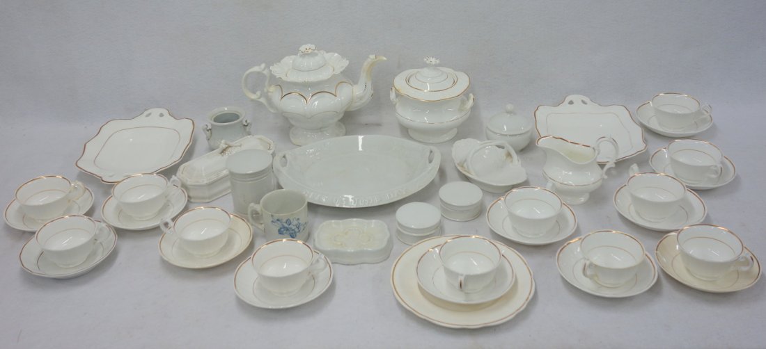 Forty pieces of china and ironstone. Thirty pieces are: Forty pieces of china and ironstone. Thirty pieces are matching white china with gold highlights including a teapot with a repair to the spout, a sugar bowl, a creamer, twelve cups and saucers and thr