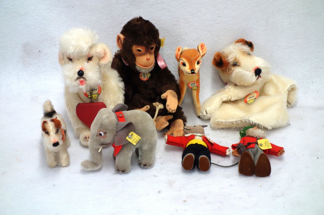 Eight Steiff plush toys including Snobby with button,: Eight Steiff plush toys including Snobby with button, tag, and collar - 8" H, Foxy 9"H hand puppet with name tag, smaller Foxy with name tag, bow and bell 4"H, a jointed Jocko with name tag and button