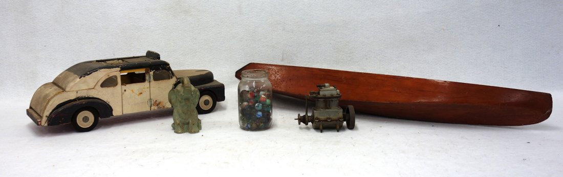 Toys including a 1940's wooden taxi cab 18"L, wooden: Toys including a 1940's wooden taxi cab 18"L, wooden speed boat hull 30"L, Boucher Mfg. Co. motor, cast metal elephant bank (missing the bottom), and a jar of old marbles.