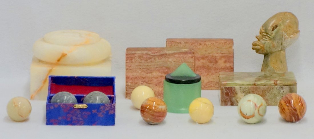 Grouping of stone and alabaster items including a: Grouping of stone and alabaster items including a carved head 5 1/2"H, six eggs, a pair of bookends, two dresser boxes, a plinth, and a pair of Chinese exercise balls in their original box.