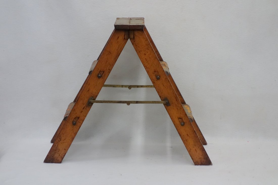 An oak double sided ladder with tooled leather wrapped: An oak double sided ladder with tooled leather wrapped steps - 21"H. Good condition leather is worn. Early 20th century.