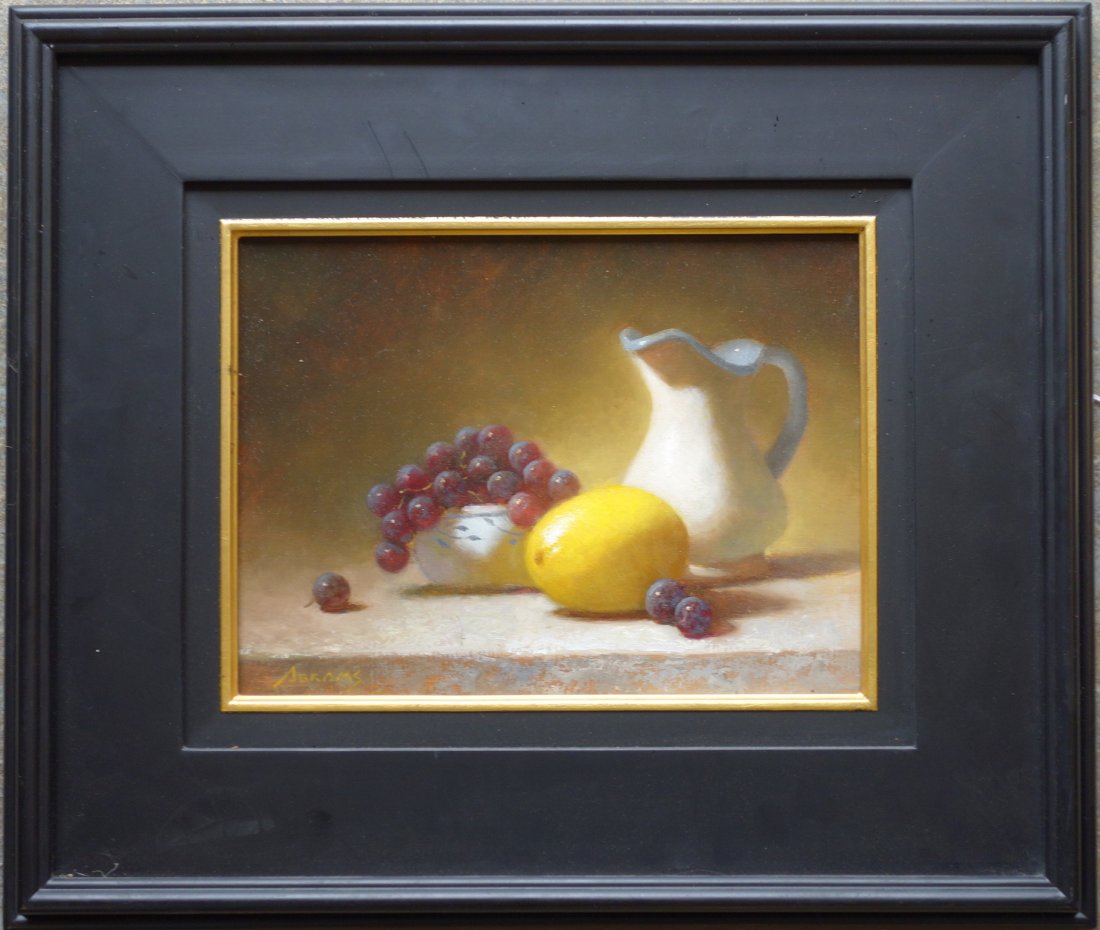 O/B Still life of white pitcher and fruit on table: O/B Still life of white pitcher and fruit on table signed Abrams (Paul Abrams, Hudson Valley NY, 20th & 21st century). Entitled on reverse "Pitcher with Lemon & Bowl of Grapes". Excellent condition. 1