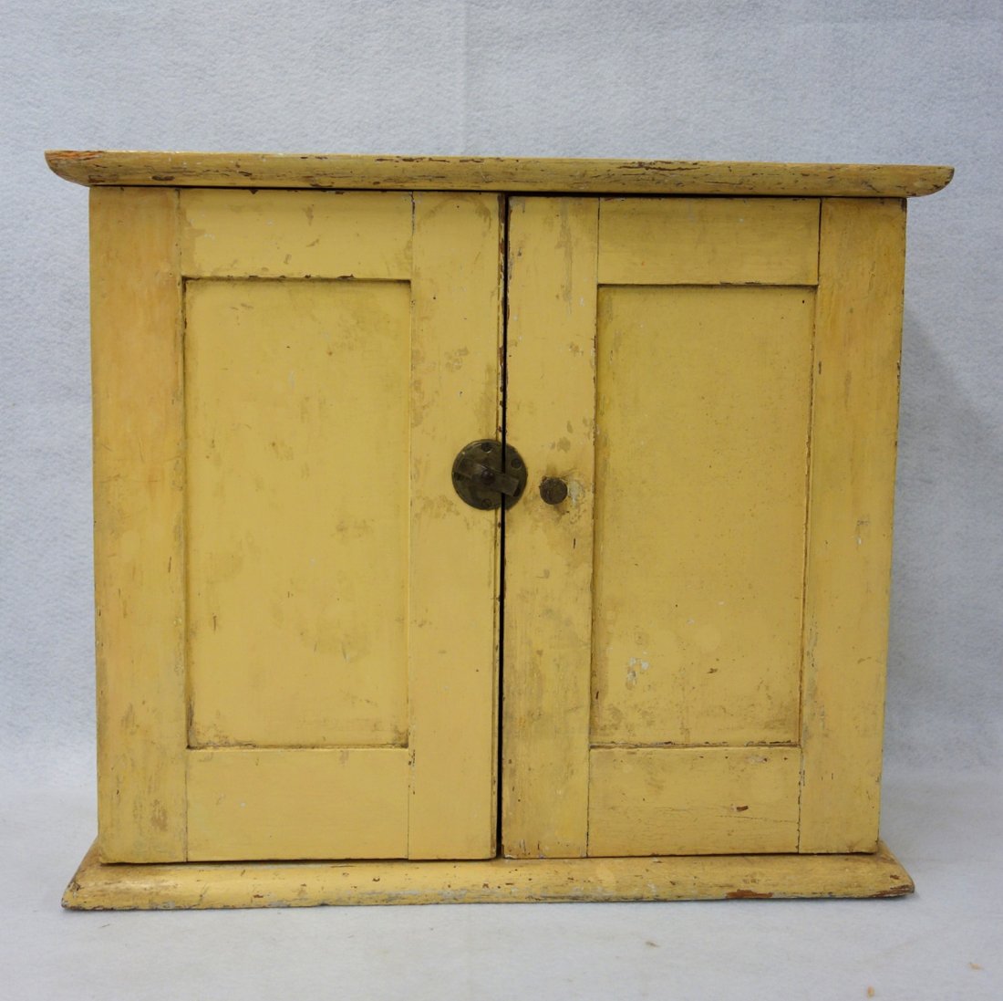 Early 2 door wall cupboard in old mustard paint over (1 of 7)