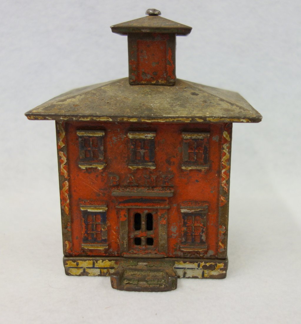 Cast iron cupola bank by J.E. Stevens, 5.5"H. Red, blue: Cast iron cupola bank by J.E. Stevens, 5.5"H. Red, blue and white paint - roof screw with minor damage (cleaned or replaced) - Retains approximately 70% original paint. Structurally sound.