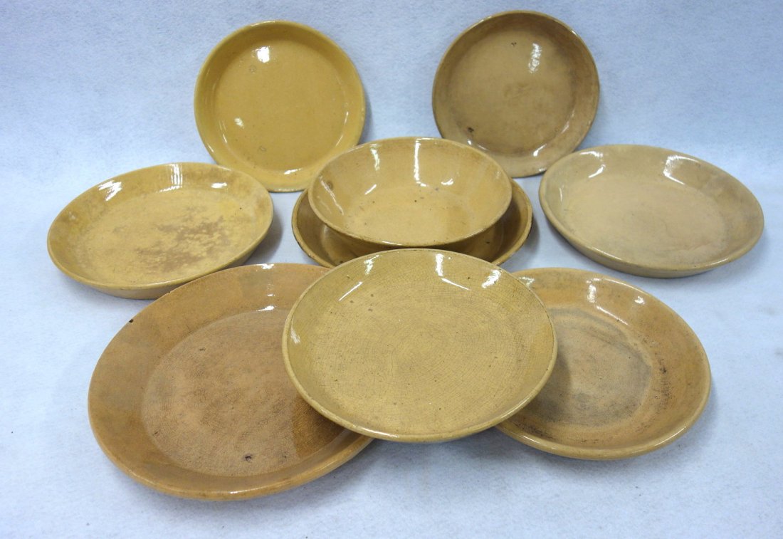 Nine yellowware items including 8 pie plates ranging in (1 of 3)