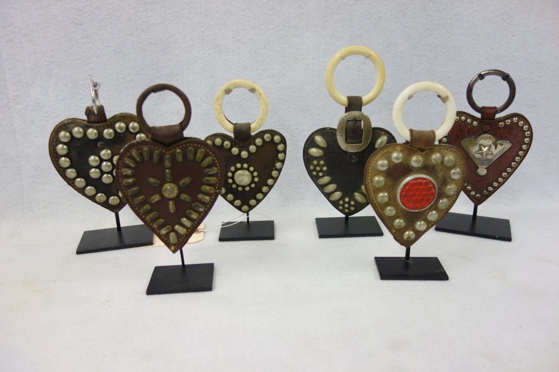 Six vintage martingale heart shaped leather pendants: Six vintage martingale heart shaped leather pendants with silver/chrome applied ornaments - one with small circular red reflector in center - all approximately 5"H - all in very good condition, circa 