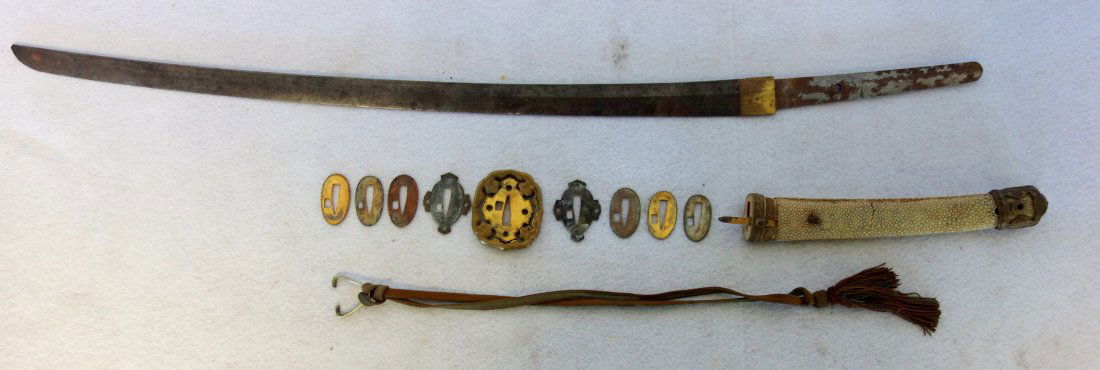 Japanese sword with bronze mounts and shark skin grip.: Japanese sword with bronze mounts and shark skin grip - oriental signature on handle. Probably WWI or earlier. 37 1/2"L. Missing sheath, dings in blade cutting edge, tip with tiny loss - fair to good