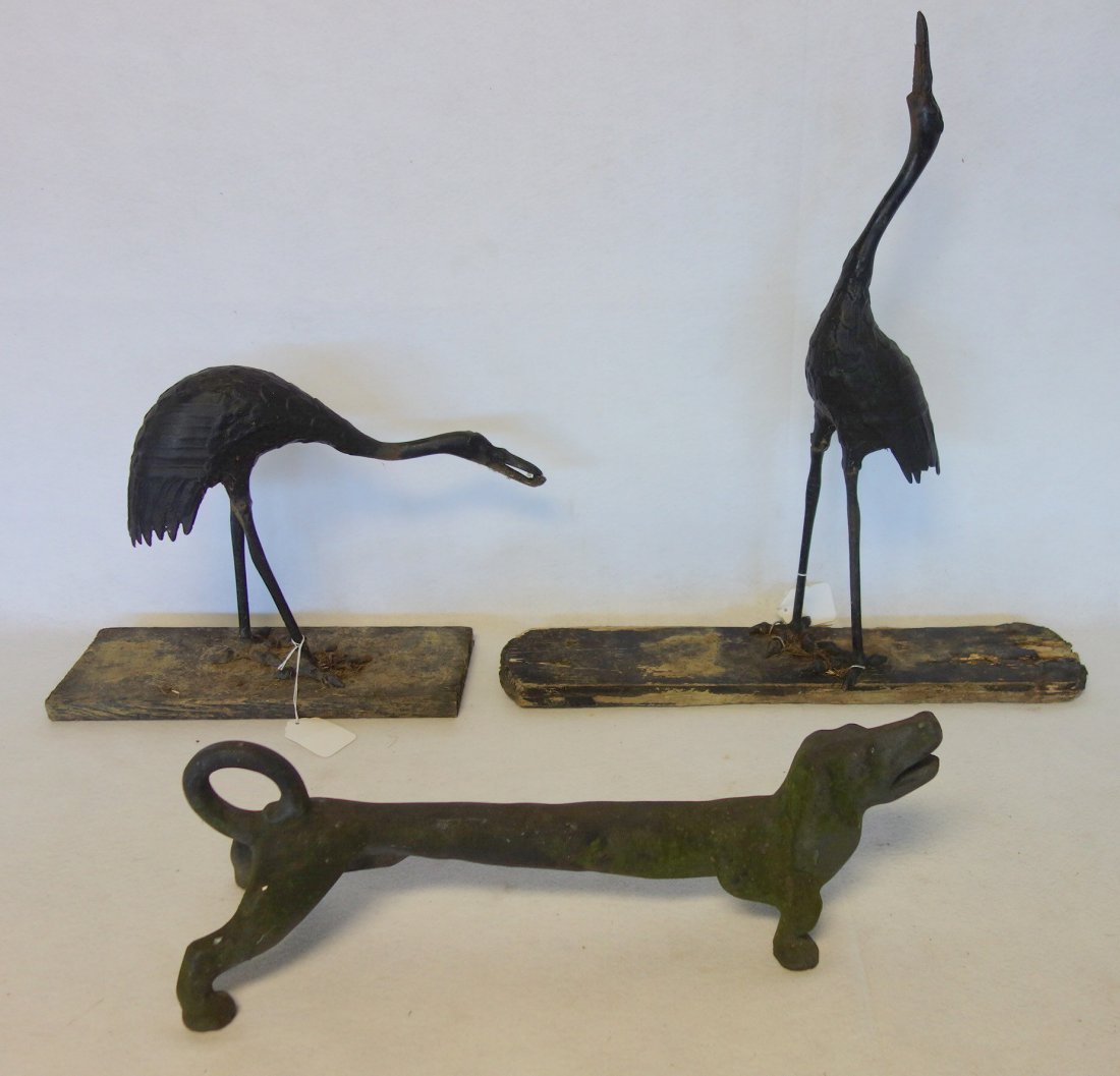 Cast iron Dachshund dog boot scrapper - 22" L -: Cast iron Dachshund dog boot scrapper - 22" L - probably early 20th century- good condition, together with a pair of hollow cast iron garden heron bird ornaments, one with losses to lower beak and tai