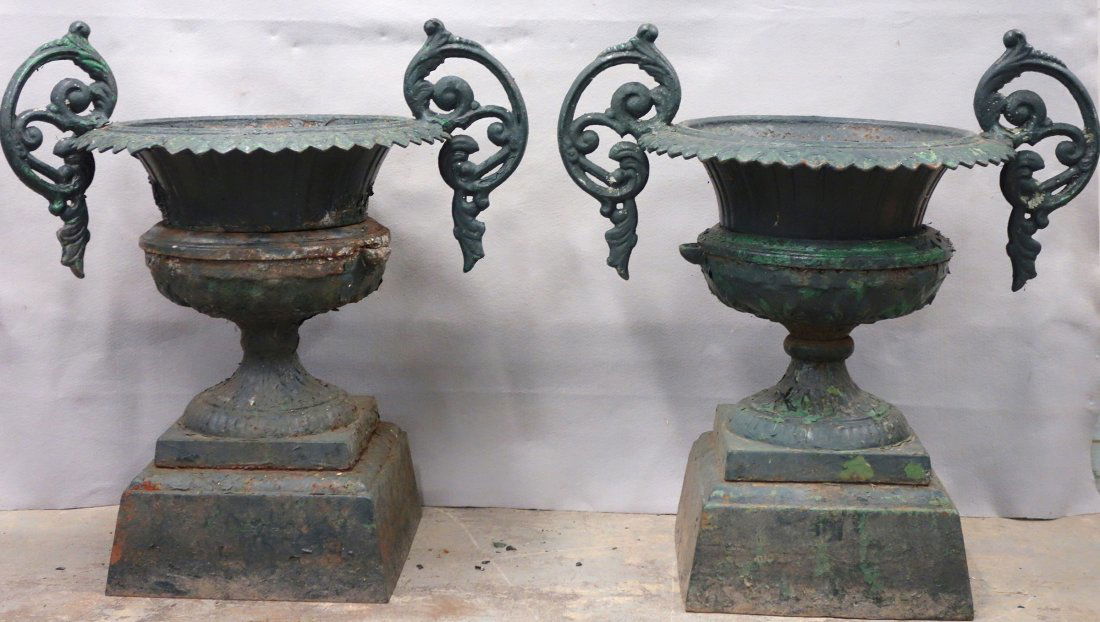 Pair of Victorian cast iron garden urns with fancy: Pair of Victorian cast iron garden urns with fancy handles in old green paint - 19th century. 32"H x 30"W x 21"D. One handle needs repair and one bowl has rust damage. Provenance: Sam and Grayson Hall