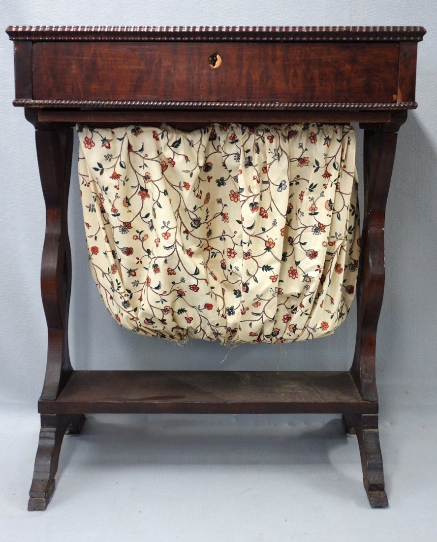 Empire single drawer sewing stand in rosewood. 29 3/4"H: Empire single drawer sewing stand in rosewood. 29 3/4"H x 24"W x 18"D. Some minor veneer losses, otherwise good condition.