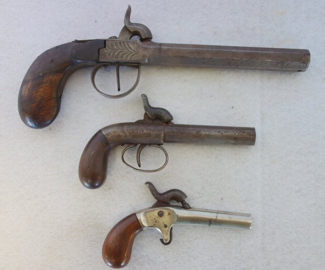 Grouping of three 19th century black powder derringers: Grouping of three 19th century black powder derringers including one Belgium and two others unknown. They range in size from 4 3/4" to 9 1/2"L. All are in fair condition.