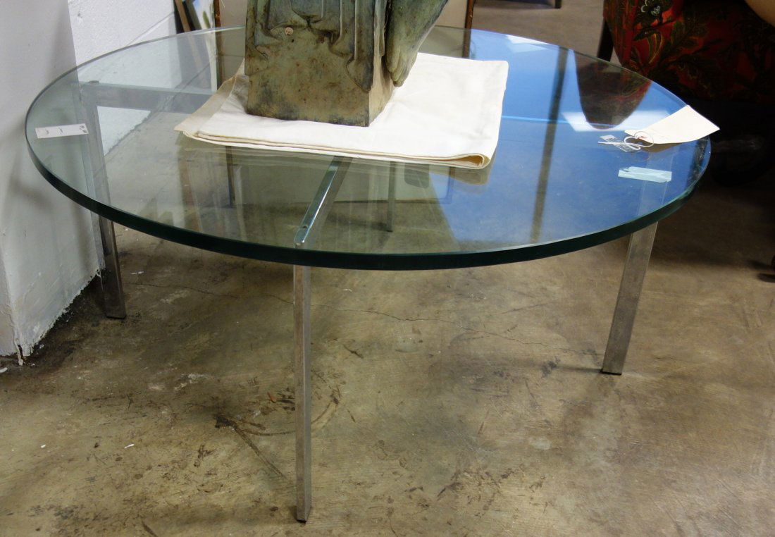 Round glass coffee table with a chrome base. 20th: Round glass coffee table with a chrome base. 20th century. 16"H x 36"Dia. Good condition.