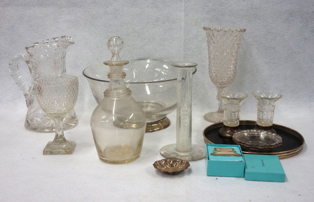 Grouping of sterling and colorless glass items: Grouping of sterling and colorless glass items including: a large glass bowl with a sterling base - 11"Dia; a hand blown decanter; a cut glass pitcher; a pressed glass celery; a small sterling shell;