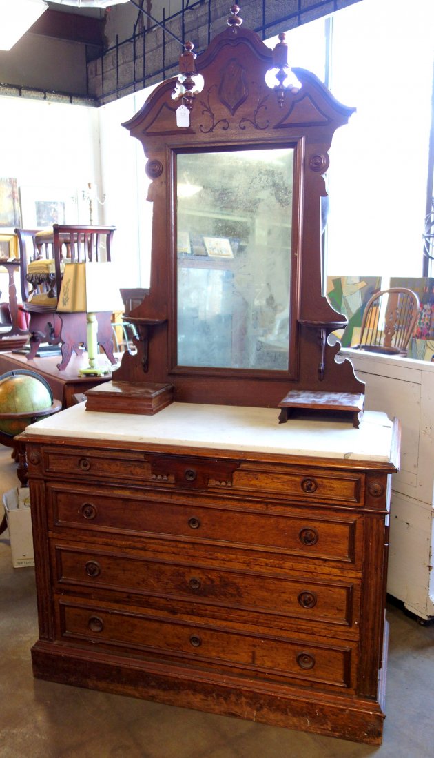 Renaissance Revival black walnut four drawer dresser: Renaissance Revival black walnut four drawer dresser with a marble top, glove boxes, candle shelves and mirror. 19th century. 87 3/4"H x 46"W x 20 1/2"D. The marble top has 2 breaks and 1 small sectio