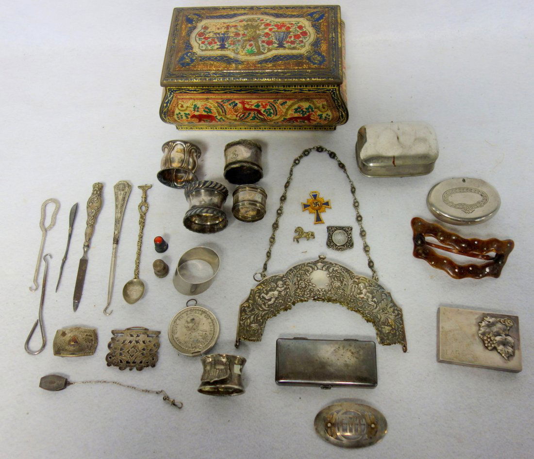 Grouping of metal decorative objects, most being silver: Grouping of metal decorative objects, most being silver plated including napkin rings, ornate silver (possibly .800) purse clasp decorated with flowers and cherubs, ornate silver plate Gillette razor