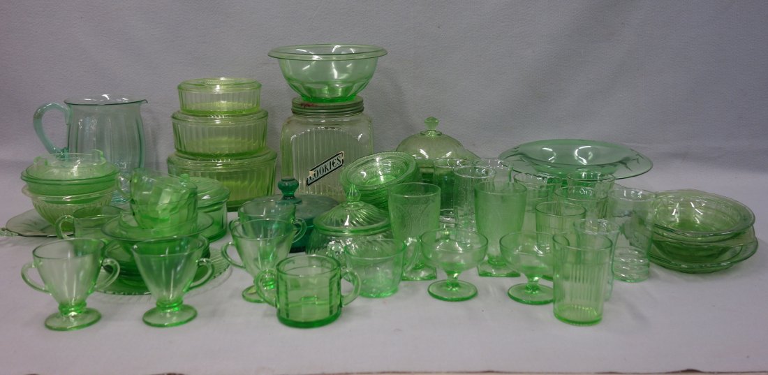 Large grouping of over 70 pieces of green glass, most: Large grouping of over 70 pieces of green glass, most depression era, including: A cookie jar; covered dishes; plates; platters; cups; tumblers etc. 20th century. Most pieces in good condition.