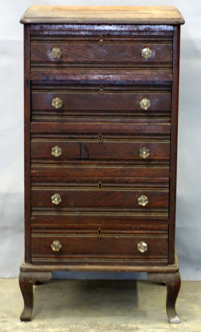 Locking oak five drawer cabinet with key and glass: Locking oak five drawer cabinet with key and glass pulls - 36 1/2"H x 18 1/2"W x 15 1/2"D. Circa 1900. Veneer loss to top otherwise in good condition.