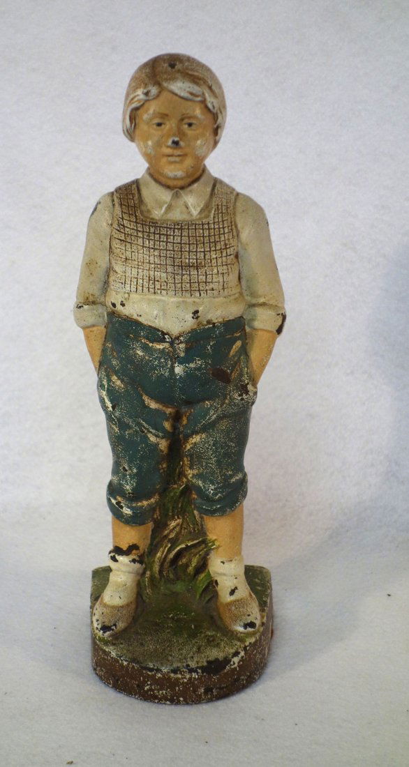 Cast iron door stop of a standing boy with hands in (1 of 3)
