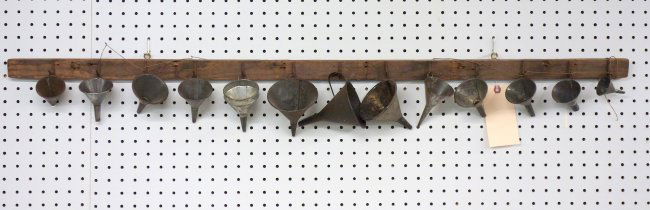 Grouping of 13 tin funnels artistically arranged on a (1 of 4)
